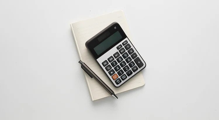 Calculator, notebook and a pen